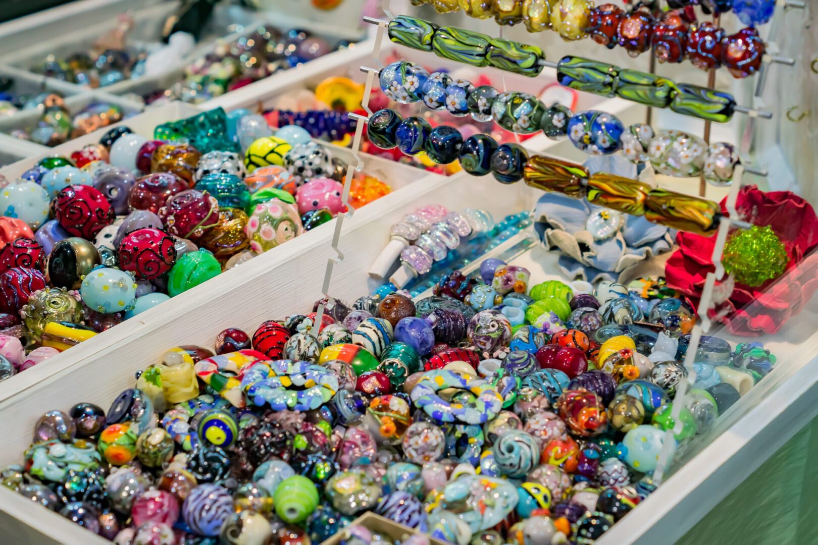 Colorful glass beads displayed in trays