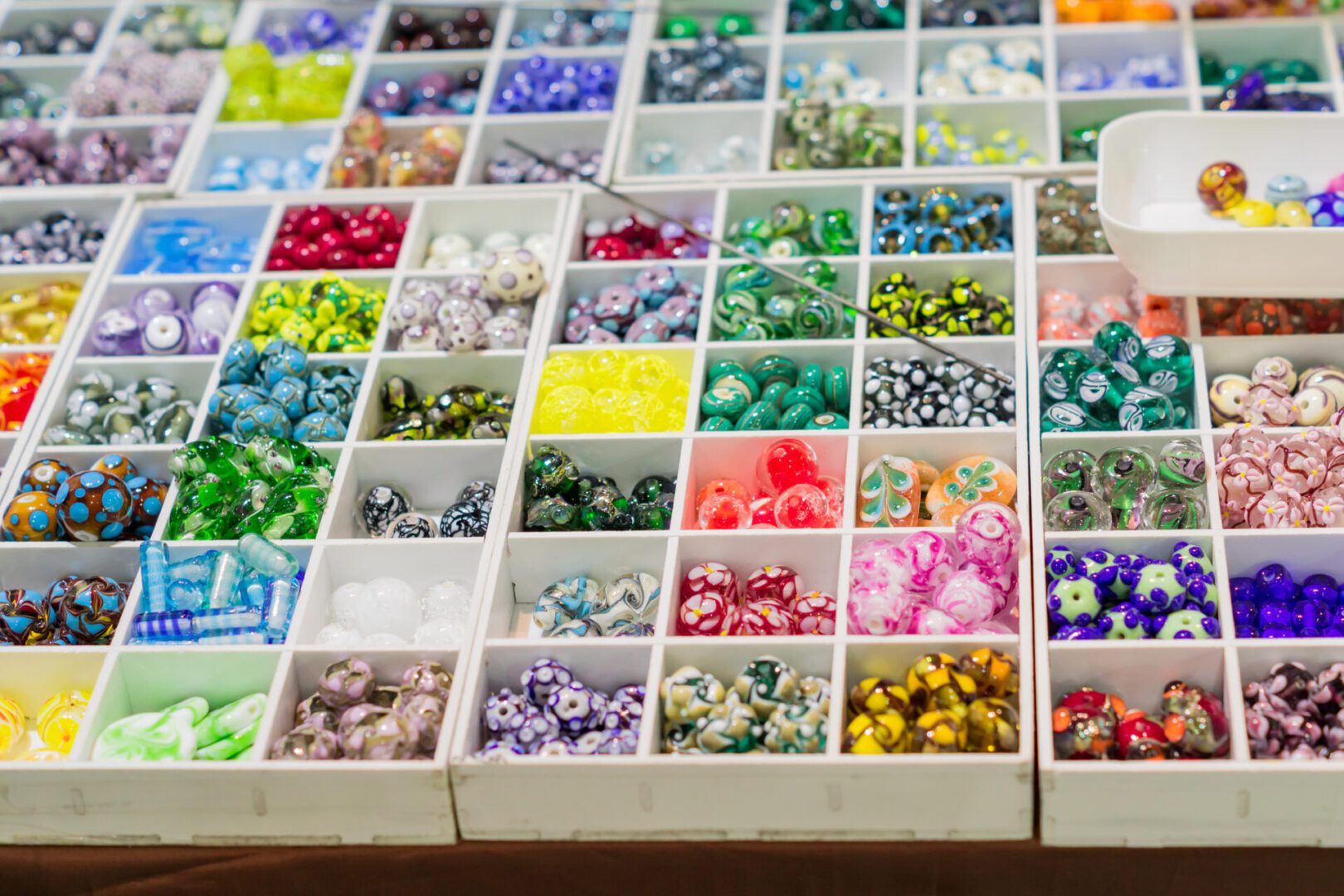 Decorative beads neatly arranged in boxes