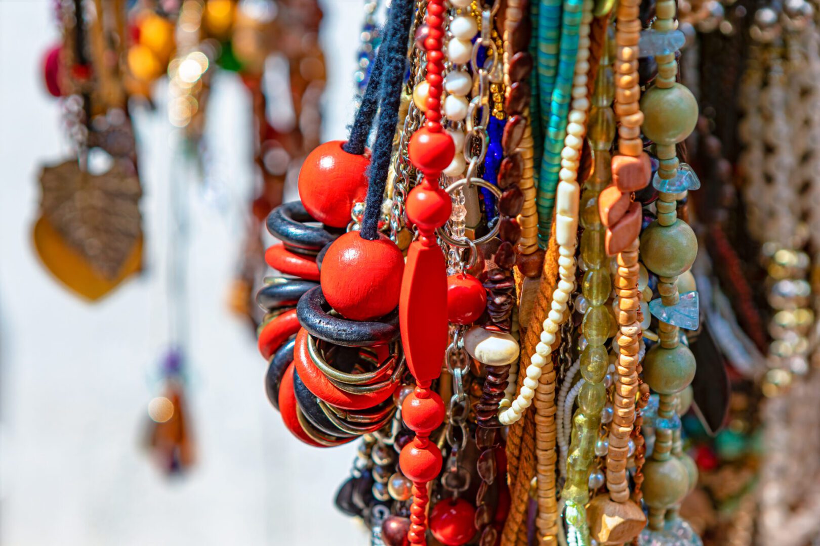 Colorful beaded necklaces hanging closely together