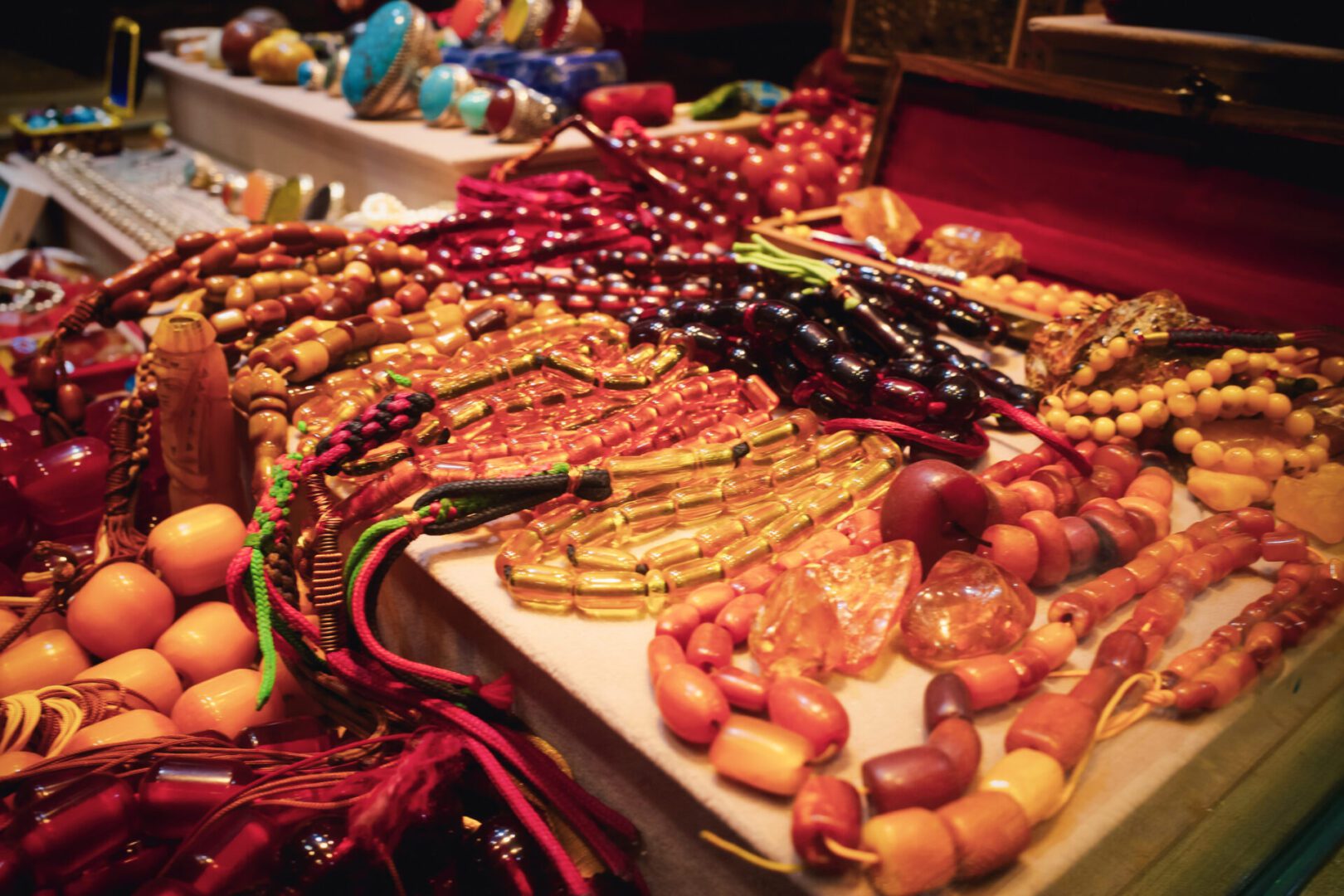 Colorful bead necklaces displayed on a market table.